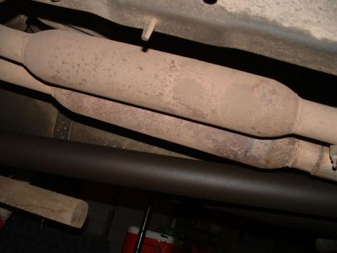 1988 Ford F-150 - Underside view of rusted exhaust pipes and catalytic converter, likely from a truck.