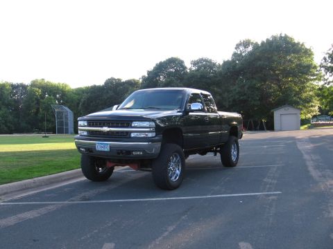 2001 Chevrolet Silverado 1500 - This black 2001 Chevrolet Silverado 1500 pickup truck features a lifted suspension and aftermarket chrome wheels.