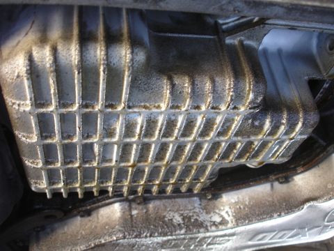 1993 Ford Taurus - The oil pan shows significant grime and oil buildup, indicating potential maintenance needs.