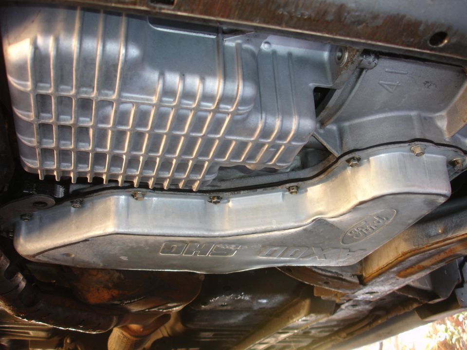 Ford oil pan with 'DHS-ODX' label visible underneath vehicle