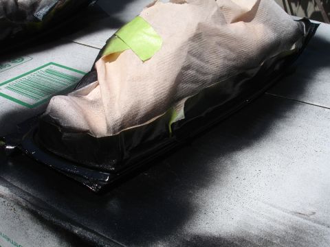 1993 Ford Taurus - Car part covered for protection, with a visible barcode on a box nearby.