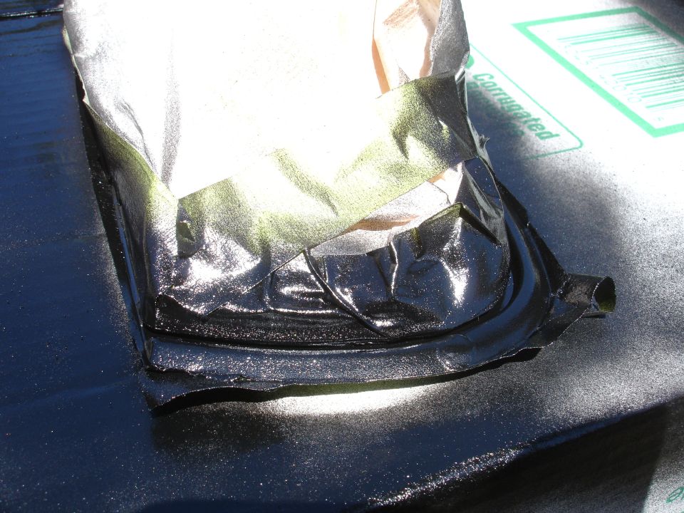 masked black part with shiny finish, possibly being painted