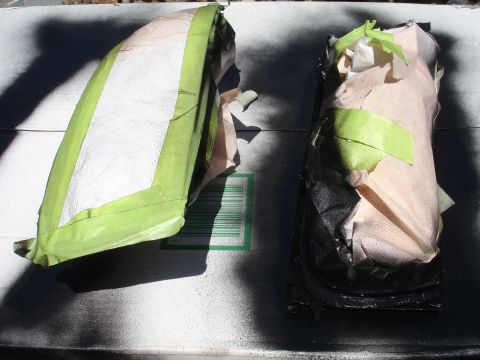 1993 Ford Taurus - Automotive parts are being prepped for painting, covered in tape and paper.
