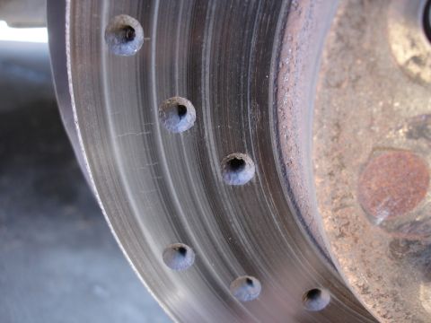 1990 Ford Taurus - Drilled brake rotor detail, showing the characteristic holes for heat dissipation.