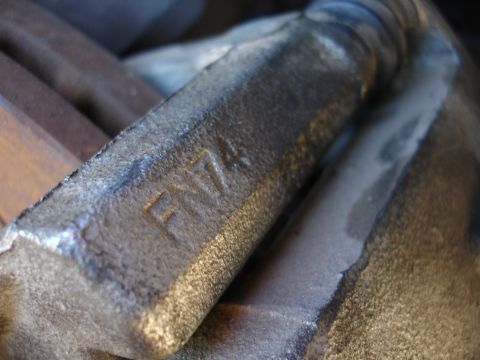 1990 Ford Taurus - A close-up view of a metal component, showing the stamped markings 'FN74'.
