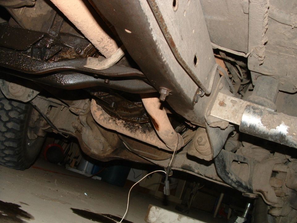 Underside of a 1988 Ford F-150 showing the frame, exhaust, and suspension components