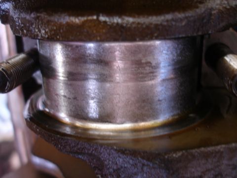 1992 Ford Taurus - Close-up of a worn engine crankshaft bearing, suggesting a need for rebuild or replacement.