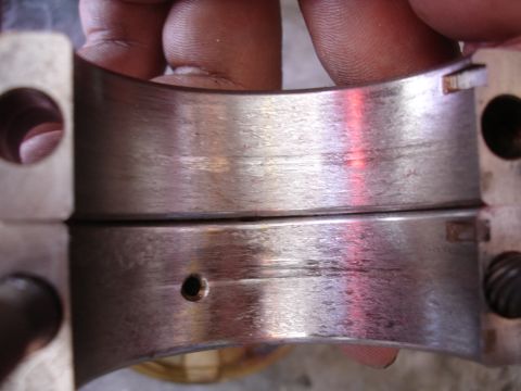 1992 Ford Taurus - Worn engine bearing halves showing scoring and damage from use.