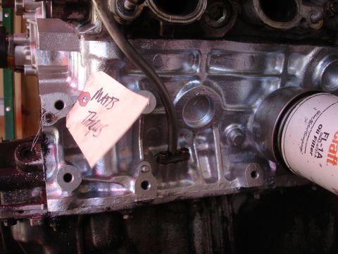 1992 Ford Taurus - A close-up view of an engine block, an oil filter and a handwritten tag.