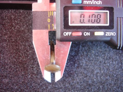 1992 Ford Taurus - A digital caliper is used to measure a small metal component, displaying a reading of 0.108 inches.