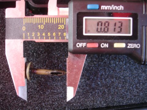 1992 Ford Taurus - A digital caliper is used to measure a small metal component, indicating its precise dimensions.