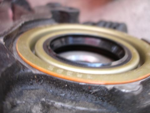 1992 Ford Taurus - A close-up view of a vehicle's engine oil seal, showing some faint numerical markings on its surface.