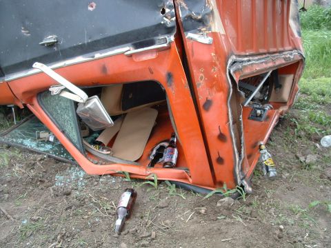 1988 Ford F-150 - This heavily damaged 1988 Ford F-150 shows the extent of its destruction, with a broken window and beer bottles scattered around.