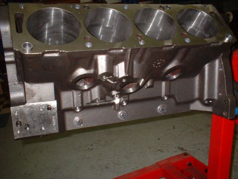 1968 Ford Galaxie - Close-up of an engine block, likely a V8, mounted on an engine stand for repair or rebuilding.