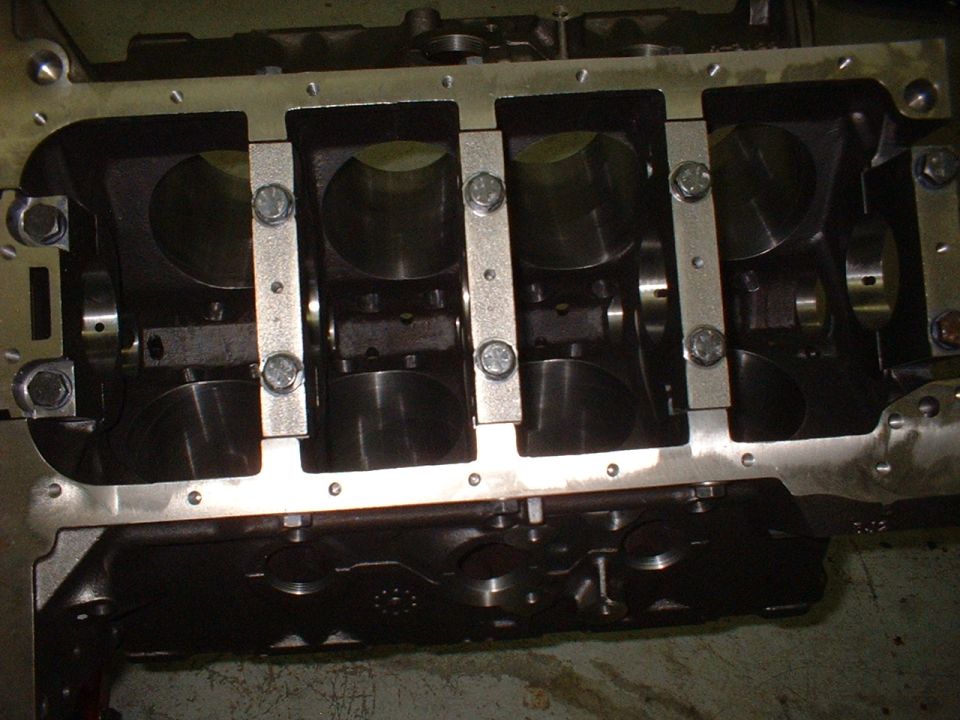 Engine block with crankshaft bearings and main caps installed