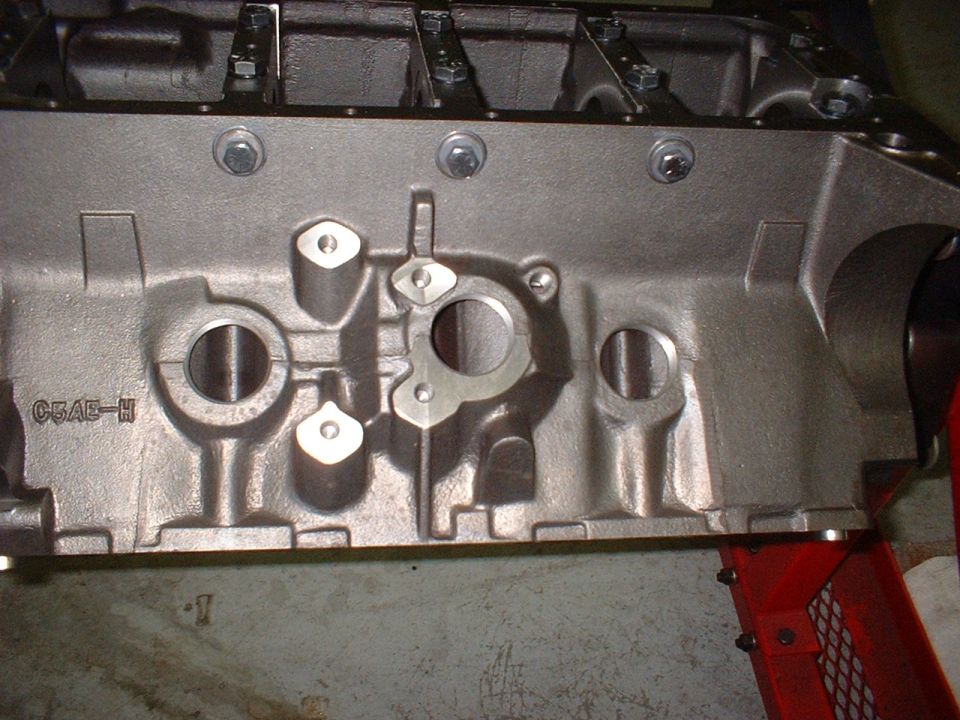 Close-up of a cast iron engine block with casting marks C5AE-H