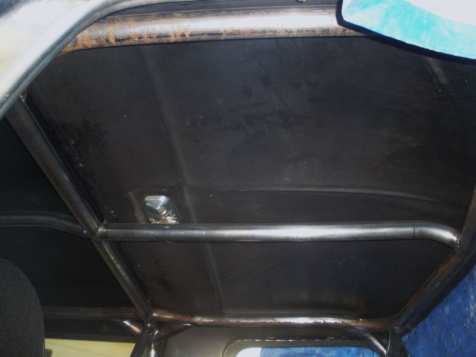Interior view of a vehicle's roof with a metal roll cage installed