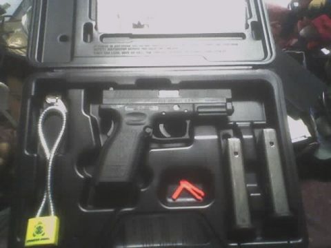 2001 Ford Crown Victoria - A pistol and its accessories are neatly arranged in a fitted case.