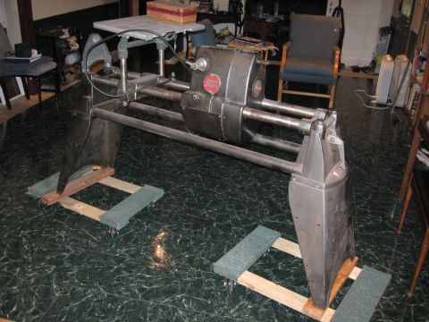 1991 Ford Bronco - Metal machine with red emblem on dollies, indoors.