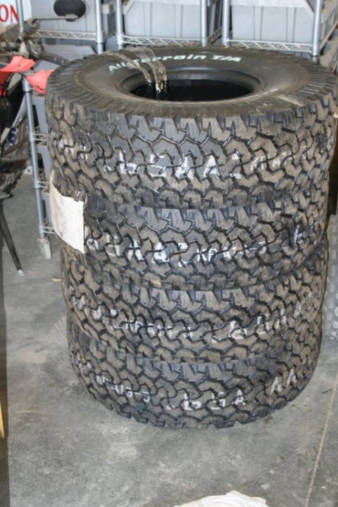 1989 Ford Bronco - A stack of four BFGoodrich All-Terrain T/A tires are shown, with white chalk markings on their sidewalls.
