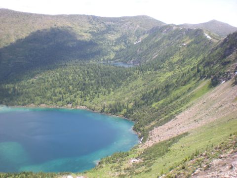 1974 Ford Ranchero - A vast mountain scene with two tranquil lakes surrounded by lush green forests under a bright sky.