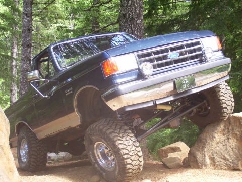 1991 Ford Bronco - This lifted Ford Bronco navigates a rocky trail, its off-road capabilities.