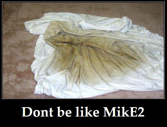 Bedding with large brown stains on a carpeted floor. Text at bottom says 'Dont be like MikeE2'