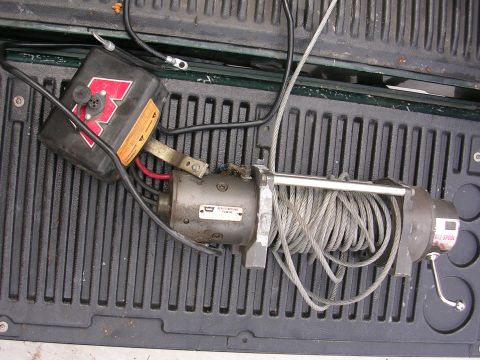 1990 Ford Bronco - A winch with a red logo and coiled cable is visible, likely a part for a vehicle.