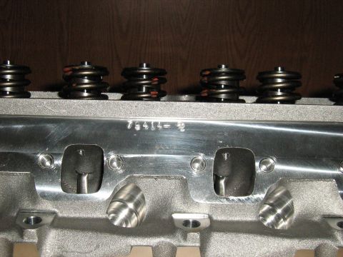1988 Mercury Grand Marquis - A close-up view of an engine cylinder head, showing valve springs and a stamped part number.