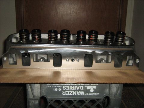 1988 Mercury Grand Marquis - A polished aluminum engine cylinder head with visible valve springs is displayed on top of a plastic crate.
