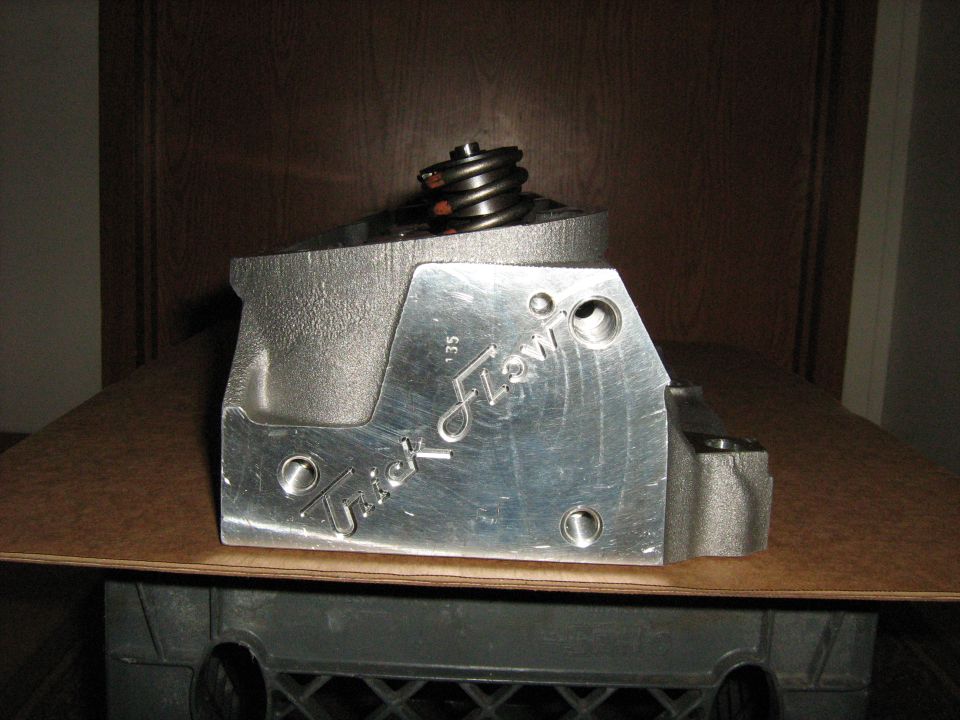 Aluminum engine part with 'Trick Flow' logo and '35' marking