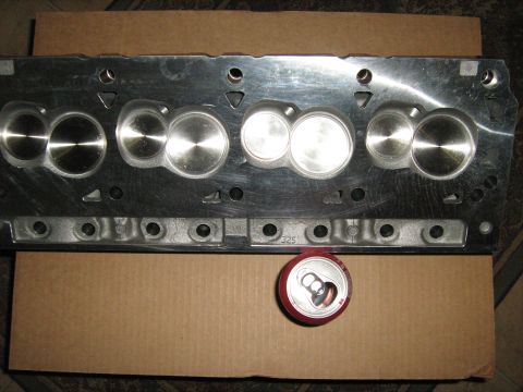 1988 Mercury Grand Marquis - A close-up view of an engine cylinder head, with a soda can placed nearby to indicate scale. The part number '325' is visible on the compon…