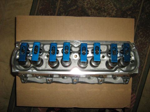 1988 Mercury Grand Marquis - A close-up view of an engine cylinder head bright blue rocker arms and valve springs.