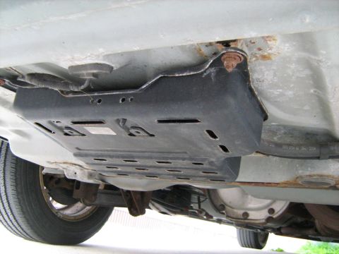 1988 Mercury Grand Marquis - Undercarriage view reveals an underbody shield and rear differential assembly.