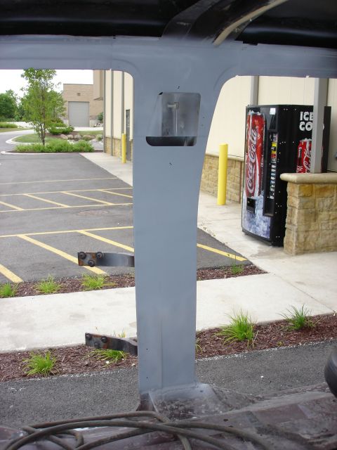 1979 Ford F-250 - The interior of a vehicle shows a gray painted pillar, with a view of a parking lot and vending machines outside.