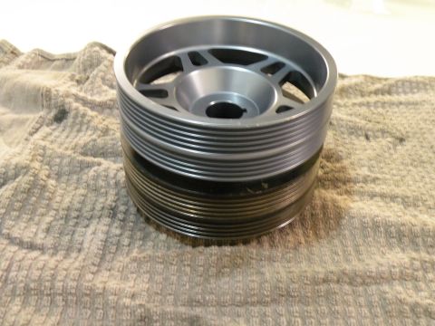 1998 Subaru Legacy - A pulley with a ribbed surface is shown on a textured cloth background.