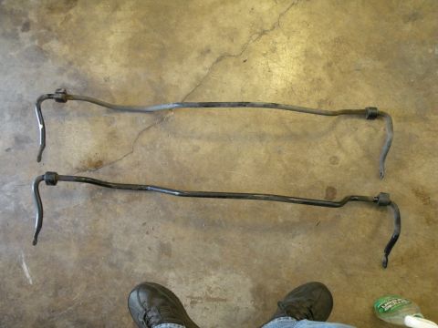 1998 Subaru Legacy - Two sway bars are shown on a concrete floor, likely for comparison or replacement.