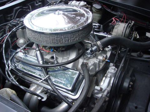 1975 Chevrolet Corvette - Close-up of an engine bay a chrome air cleaner and polished valve covers.