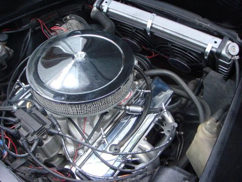 1975 Chevrolet Corvette - Close-up view of a modified engine bay, a chrome air cleaner and aftermarket cooling system.