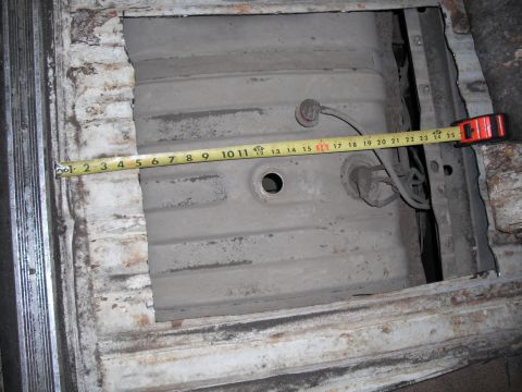 1991 Ford Bronco - A tape measure is placed across a vehicle's fuel tank, showing its dimensions.