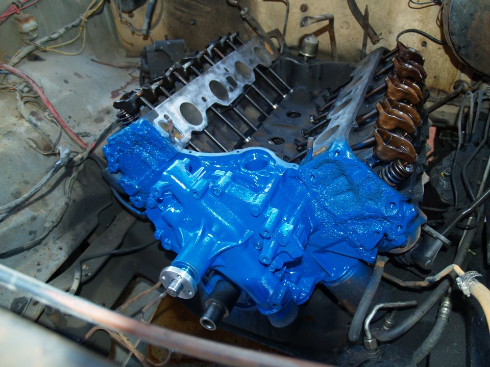 V8 engine block painted blue with camshaft sitting in engine bay