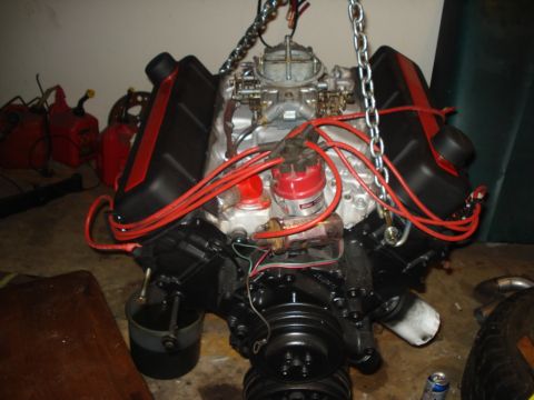 1978 Ford Bronco - This engine, likely not from a 1978 Ford Bronco, features prominent red spark plug wires and a dual carburetor setup.