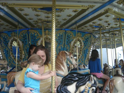 2000 Ford Crown Victoria - A carousel scene with people riding on the horses.