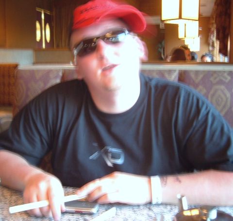 2006 Ford E350 - A person wearing a red bandana and sunglasses is seated at a table, holding chopsticks.