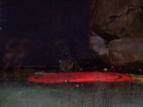1985 Ford Bronco - A red object is visible underwater, with large rocks forming the background.