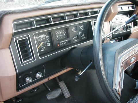 1990 Ford Taurus - The interior of a vehicle shows the dashboard with gauges and the steering wheel.