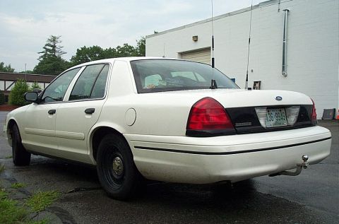 2001 Ford Crown Victoria - White 2001 Ford Crown Victoria parked outdoors, viewed from the rear quarter panel.