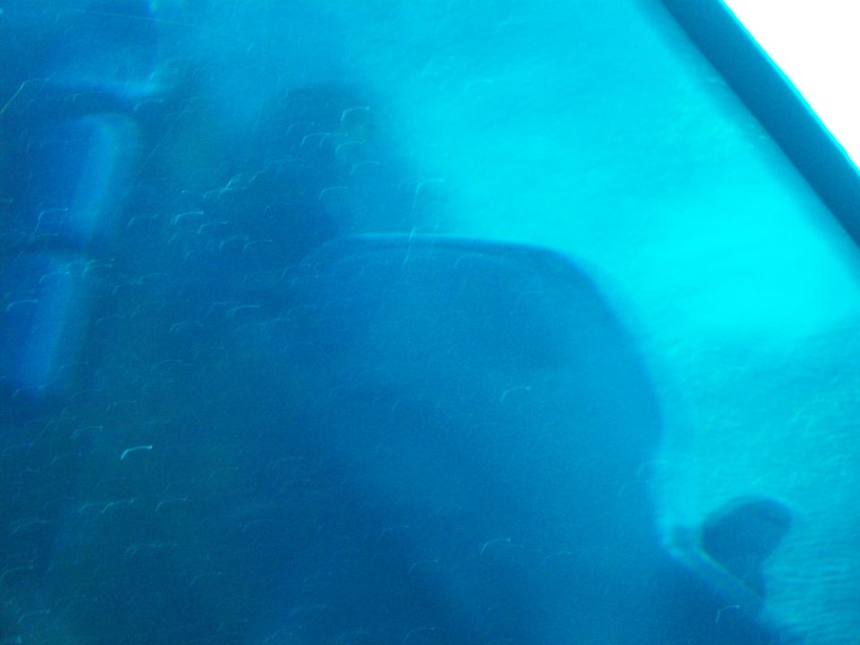 Blue interior of a vehicle with blurred shapes suggesting seats and dashboard