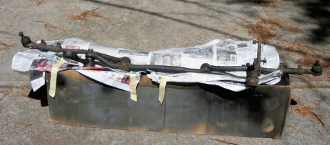 1976 Ford Ranchero - Steering linkage parts are displayed on a surface, possibly for repair or sale.