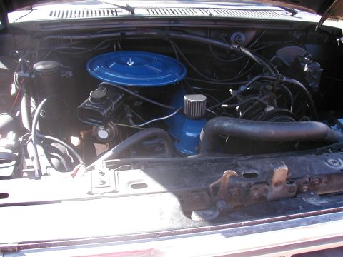 1990 Ford Taurus - Engine bay details with various hoses and components visible.